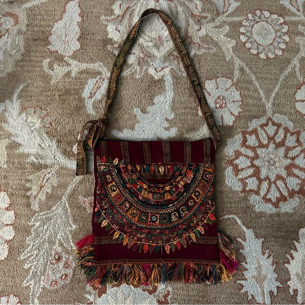 vintage maroon bag with colorful embroidery and fringe